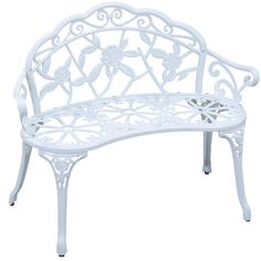 a white metal bench with flowers on it