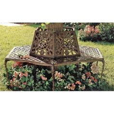 a wooden bench sitting on top of a lush green grass covered park area next to flowers