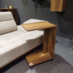 a wooden table sitting on top of a white couch