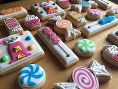 decorated cookies and candies are arranged on a table