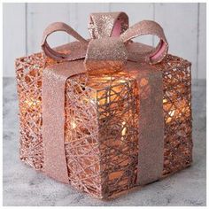 a gift box that is wrapped in pink ribbon and has a bow on the top