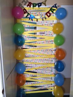 a birthday decoration with balloons and streamers