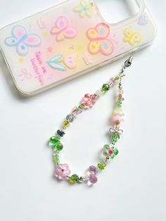 a cell phone case with a beaded necklace on it