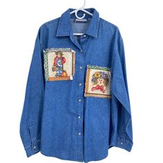 a blue jean shirt with patches on the chest and two different designs on the front