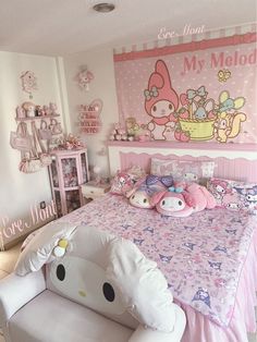 a bedroom decorated in pink and white with hello kitty decorations