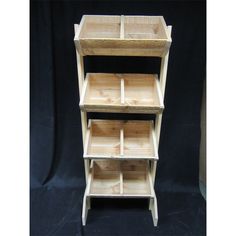 three wooden shelves stacked on top of each other in front of a black background,