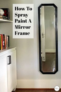 a mirror sitting on the side of a wall next to a white cabinet and book shelf