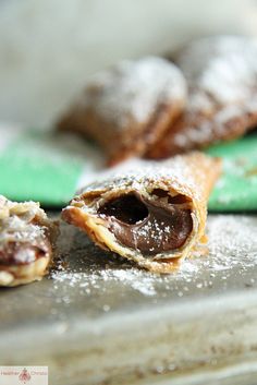 some food that is on a table and has powdered sugar on top of it