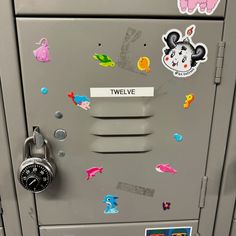 a locker with several stickers on it and a padlock attached to the door