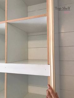 someone is holding up the shelves in their room to show them how they are built