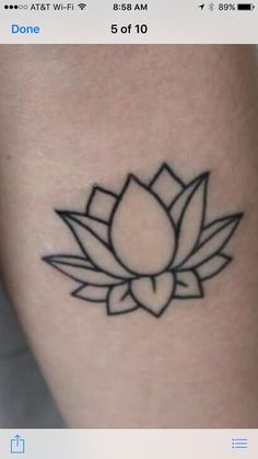 a lotus tattoo on the side of a woman's leg