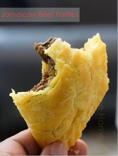 a hand holding up a piece of food with meat in it's center and the word jamaican beef patties on top