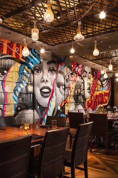 a restaurant with large murals on the wall