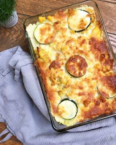 a casserole dish with zucchini and cheese