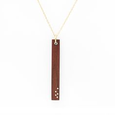 PRICES MAY VARY. 5th Anniversary Necklace: An elegant wood pendant with five gold inlay dots, symbolizing five years of marriage or partnership. The wood is sanded to a silky-smooth finish and treated with natural oil for a luxurious feel. A perfect gift for celebrating your 5th anniversary. Necklace Materials: Pau Ferro wood and 14K gold fill Wood Pendant Dimensions: 44mm x 6mm x 3mm Chain Length: 16" or 18" with 2" extension chain for extra length versatility (model in listing image is wearing Anniversary For Wife, Gold Bar Pendant Necklace, Gold Bar Pendant, Wood And Gold, Wood Anniversary, Anniversary Necklace, 5 Year Anniversary, Bar Pendant Necklace, 5th Anniversary