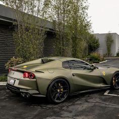 a green sports car parked in a parking lot