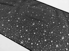 black and white photograph of an umbrella with stars on it