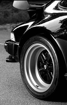 the front end of a black sports car