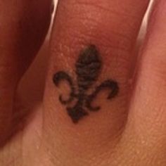 a close up of a person's finger with a tattoo on it