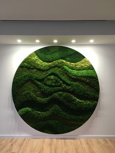 a large round painting on the wall in an empty room