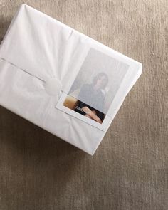 an open white gift box with a photo on it