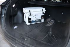 a cooler sitting in the trunk of a car with an air vent on it's side