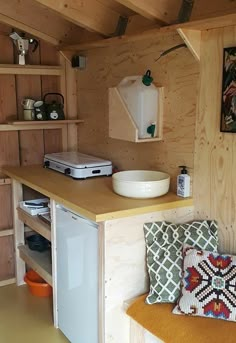 a kitchen with wooden walls and shelves filled with items