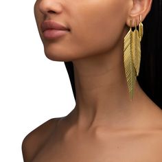 Accent your ear with our small 18K yellow gold Feather Drop Earrings. Measuring approximately 1.5 inches in length they're the perfect everyday earring for a bit of subtle flair or as an accent earring in your second or third piercing. For a funkier, head-turning look, we suggest wearing these small feather earrings in your second or third piercing paired with our Medium Feather Earrings. Apollo Outfit, Dangly Gold Earrings, Third Piercing, Gold Feather Earrings, Double Heart Ring, Gold Feathers, Italian Craftsmanship, Feather Jewelry, Golden Glow