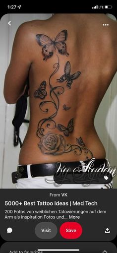 the back of a woman's body with butterflies and roses tattooed on her stomach