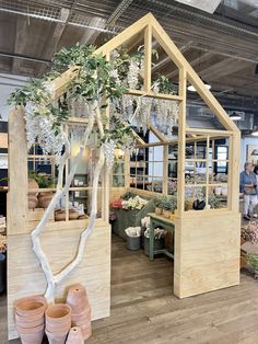 an indoor greenhouse with potted plants inside