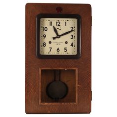 an old fashioned wooden clock with pendulum