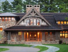 a large stone and wood house with lots of windows