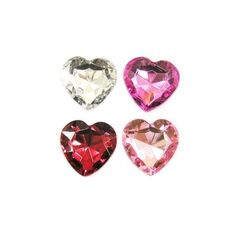 three heart shaped jewels on a white background