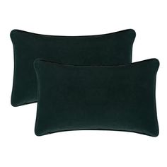 two dark green velvet pillows on a white background