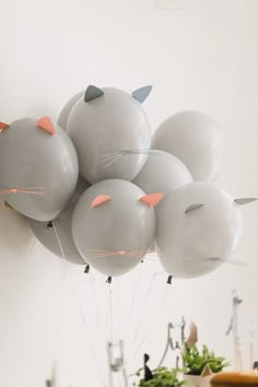 a bunch of balloons that have cats on them