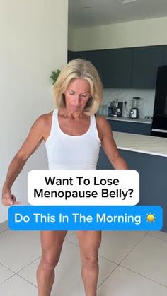 a woman in white shirt standing on tiled floor next to counter top with text reading, want to lose menopase belly? do this in the morning