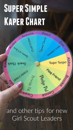 a person holding up a colorful wheel that says, super simple kaper chart and other tips for new girl scout leaders