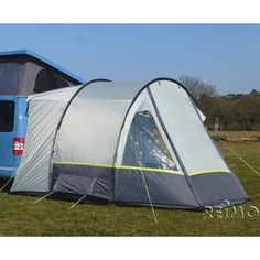 a blue van is parked next to a tent