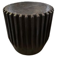 a wooden stool with pleated design on the top