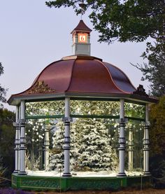 a gazebo is lit up with christmas lights