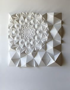 two pictures with different shapes and sizes of paper on the wall, one is made out of