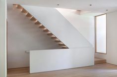 an empty room with stairs leading up to the second floor