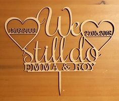 a cake topper that says we still do with two hearts and the words,