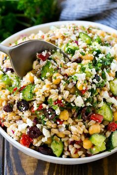 a white bowl filled with rice and vegetables