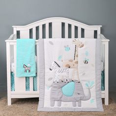 a baby crib bedding set with a giraffe and zebra on it