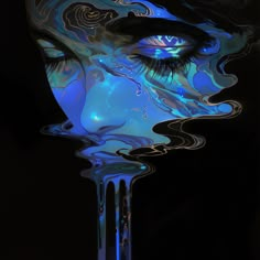 a woman's face is covered in blue and black liquid with her eyes open