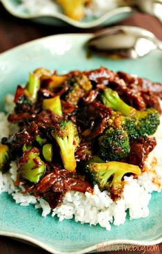 a blue plate topped with rice and broccoli