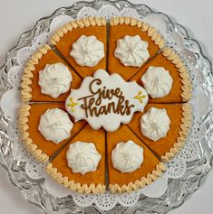 a pie with white frosting and the words give thanks written on it