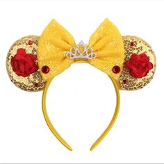 a yellow minnie mouse ears headband with red roses on the side and a tiara