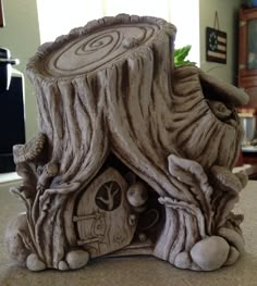 a small house made out of tree stumps